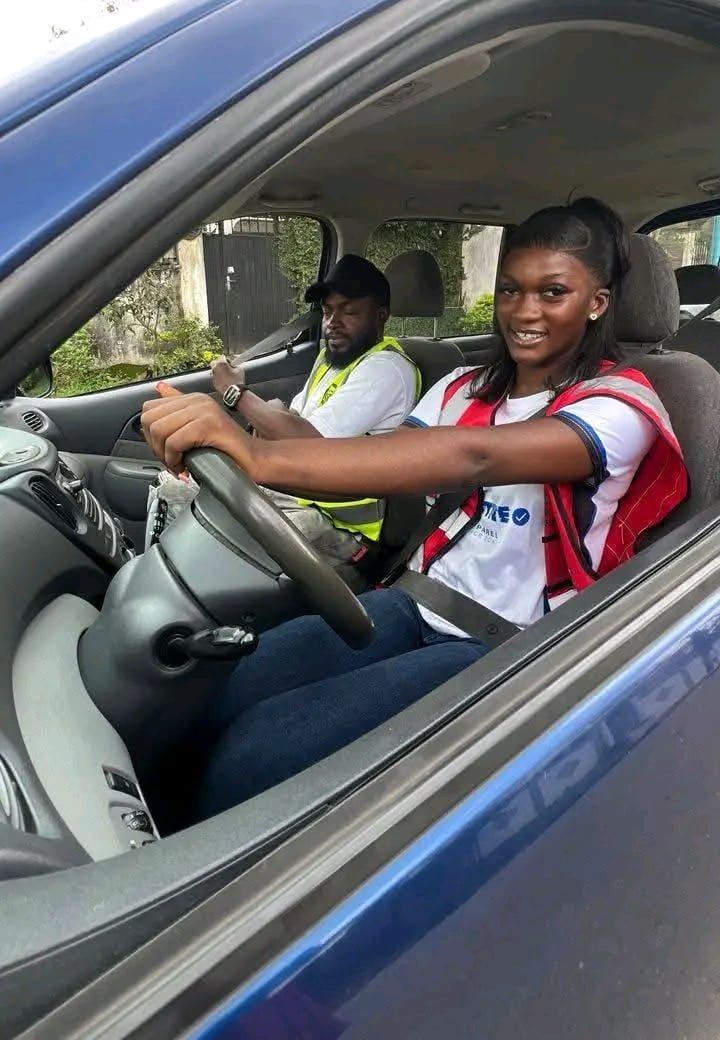 A Chia Auto-Ecole student at the wheel with her instructor beside her, Douala